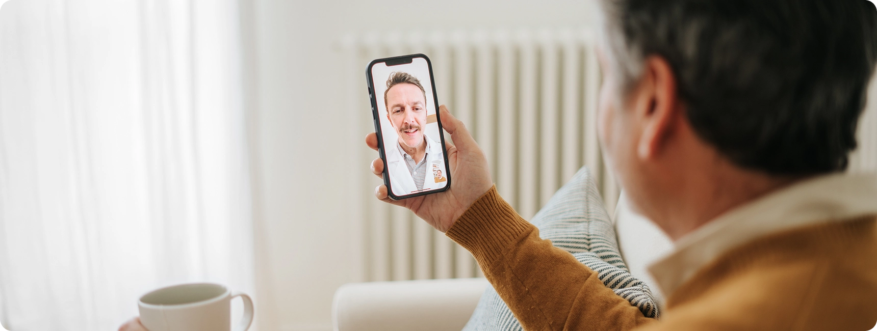Man video chatting on smartphone at home.
